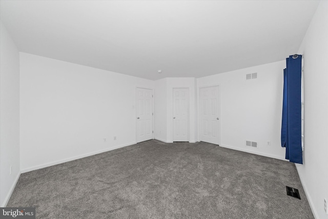 605 Red Timber Ln, Smyrna, DE 19977 - unfurnished bedroom with dark colored carpet and baseboards