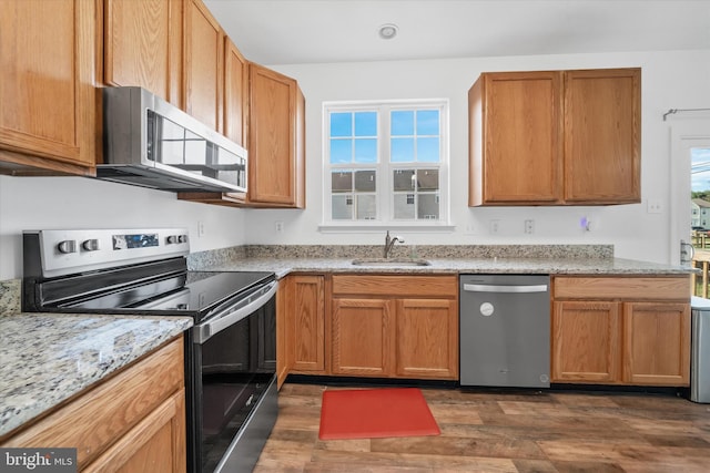 605 Red Timber Ln, Smyrna, DE 19977 - kitchen with stainless steel appliances, dark wood-style flooring, and light stone countertops
