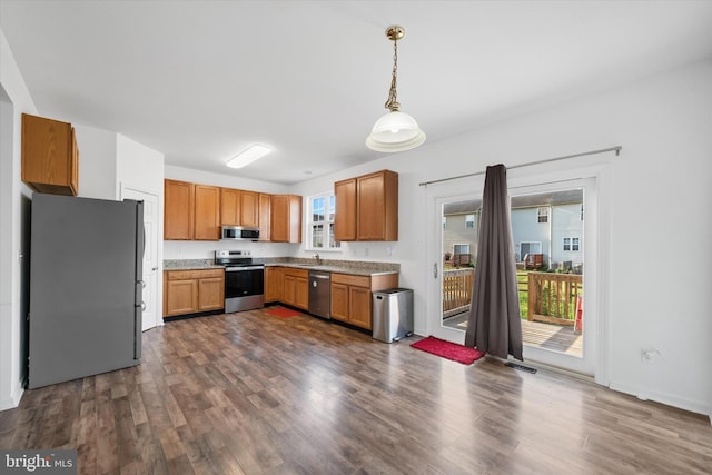605 Red Timber Ln, Smyrna, DE 19977 - kitchen with appliances with stainless steel finishes, dark wood finished floors, pendant lighting, light countertops, and brown cabinetry