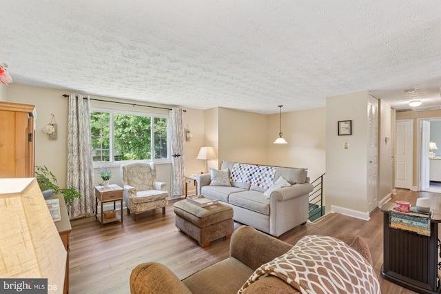 12706 Northcliff Rd, Bowie, MD 20720 - living area featuring a textured ceiling, wood finished floors, and baseboards