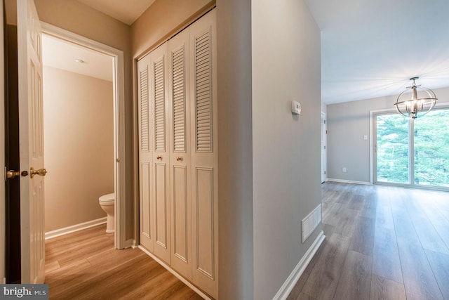 691 Metro Ct Unit 9, West Chester, PA 19380 - corridor with wood finished floors, a chandelier, and baseboards