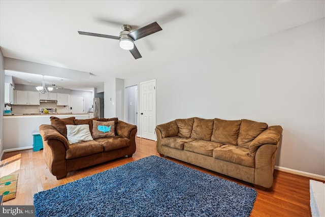 19112 Gunnerfield Ln, Germantown, MD 20874 - living area with ceiling fan, light wood-type flooring, a chandelier, and baseboards