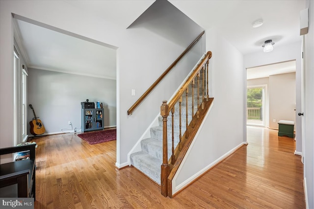 19112 Gunnerfield Ln, Germantown, MD 20874 - stairway with wood finished floors, baseboards, and ornamental molding