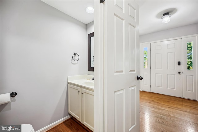 19112 Gunnerfield Ln, Germantown, MD 20874 - half bathroom featuring vanity, healthy amount of natural light, hardwood / wood-style flooring, and toilet