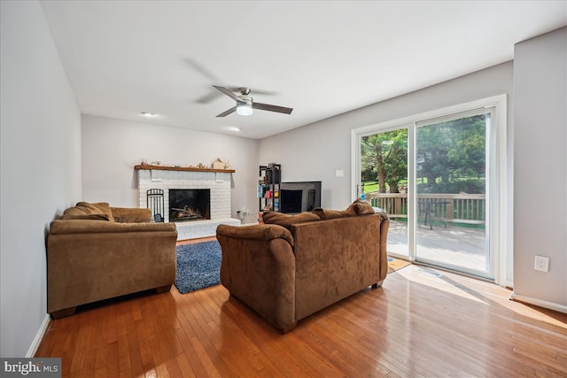 19112 Gunnerfield Ln, Germantown, MD 20874 - living area with hardwood / wood-style flooring, a ceiling fan, a brick fireplace, and baseboards