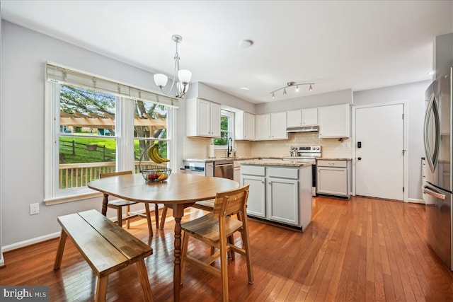 19112 Gunnerfield Ln, Germantown, MD 20874 - dining room featuring hardwood / wood-style flooring, a chandelier, and baseboards