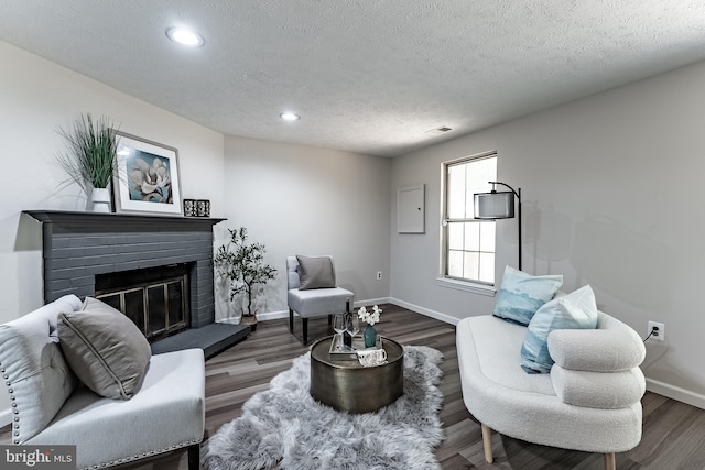7910 Peyton Forest Trl, Annandale, VA 22003 - living room with recessed lighting, a textured ceiling, a fireplace, and wood finished floors