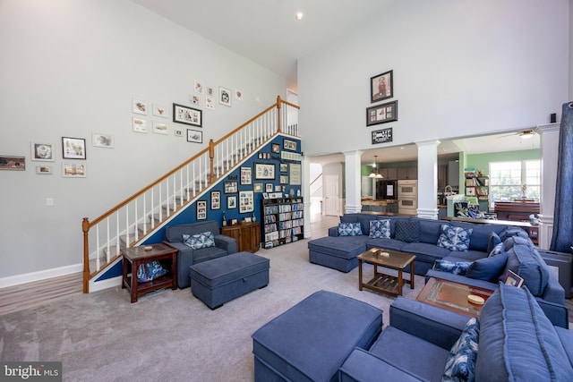 2200 Summerdale Ln, Linfield, PA 19468 - living area with ornate columns, a towering ceiling, stairway, ceiling fan, and carpet