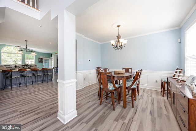 2200 Summerdale Ln, Linfield, PA 19468 - dining room featuring a chandelier, light wood-style floors, a wainscoted wall, a decorative wall, and ornamental molding