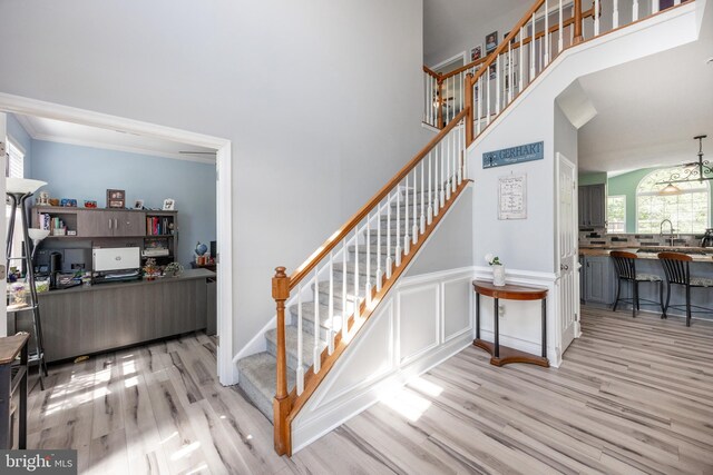 2200 Summerdale Ln, Linfield, PA 19468 - stairway with wood finished floors, a towering ceiling, and a wainscoted wall
