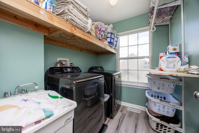 2200 Summerdale Ln, Linfield, PA 19468 - washroom with washing machine and dryer, wood finished floors, plenty of natural light, and baseboards