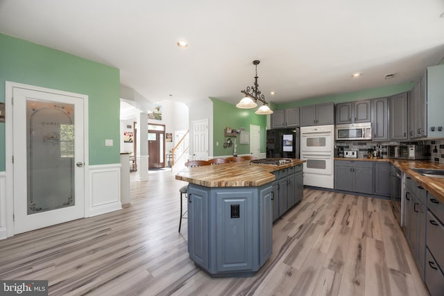 2200 Summerdale Ln, Linfield, PA 19468 - kitchen featuring butcher block countertops, appliances with stainless steel finishes, gray cabinetry, light wood finished floors, and a center island
