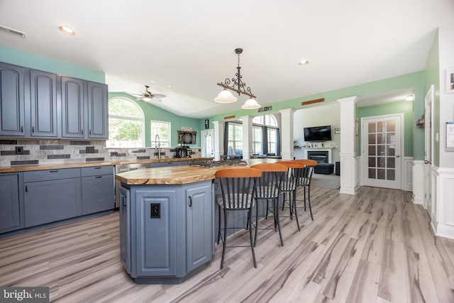 2200 Summerdale Ln, Linfield, PA 19468 - kitchen with wood counters, a breakfast bar area, vaulted ceiling, a ceiling fan, and tasteful backsplash