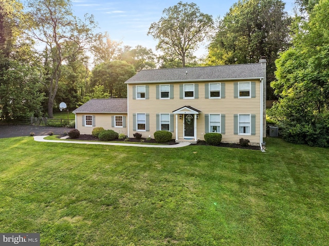 1576 Delong Dr, Downingtown, PA 19335 - colonial home featuring a chimney, cooling unit, and view of scattered trees