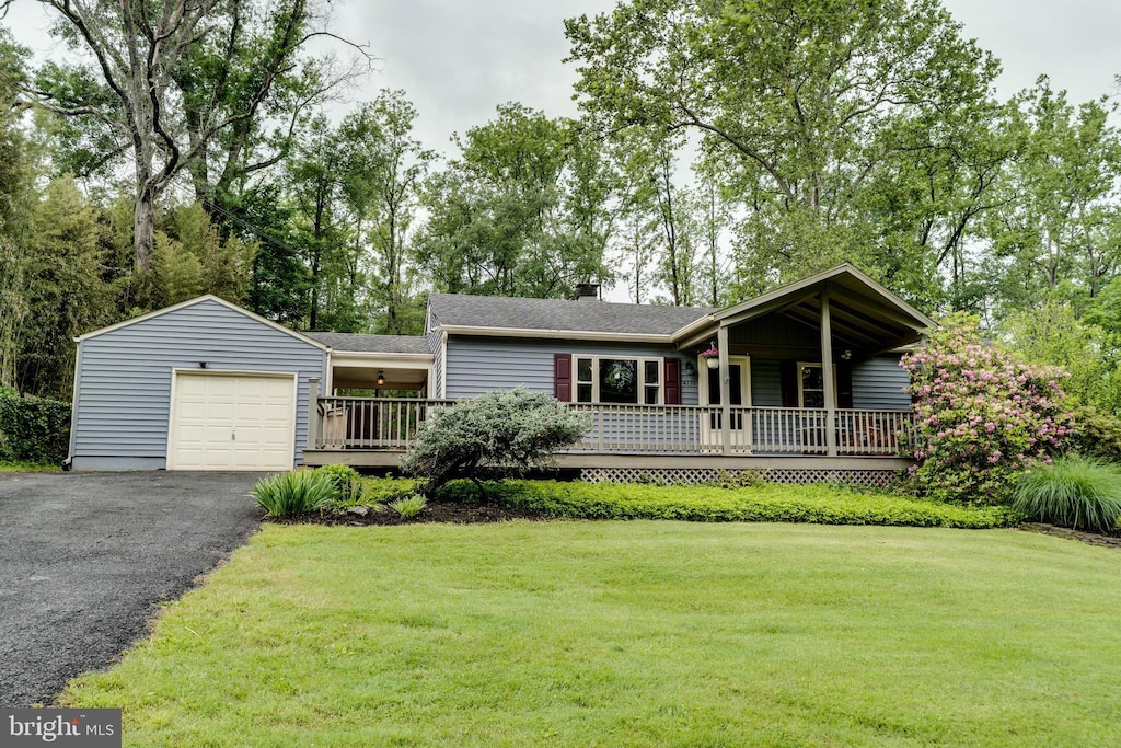 4130 Painted Sky Rd, Reading, PA 19606 - view of front of property featuring a front lawn, driveway, a wooden deck, a chimney, and a shingled roof