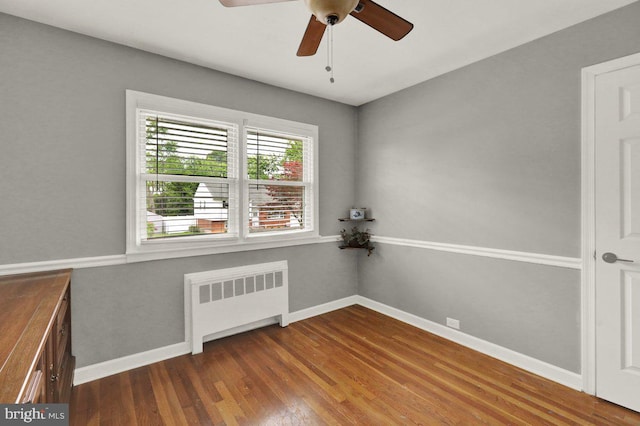 102 Radcliffe Ave, Reading, PA 19609 - unfurnished room with radiator heating unit, dark wood finished floors, a ceiling fan, and baseboards