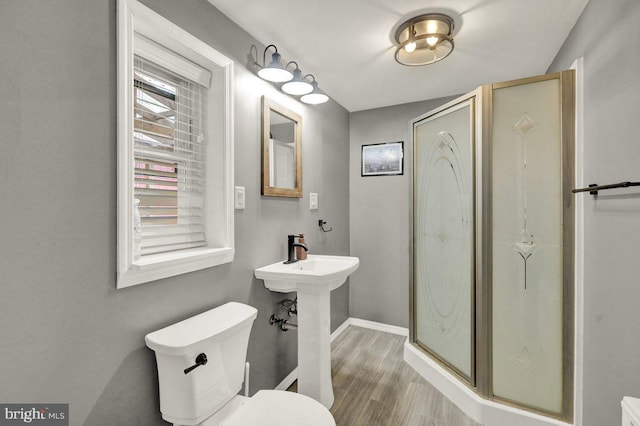 102 Radcliffe Ave, Reading, PA 19609 - bathroom with wood finished floors, a stall shower, toilet, and baseboards