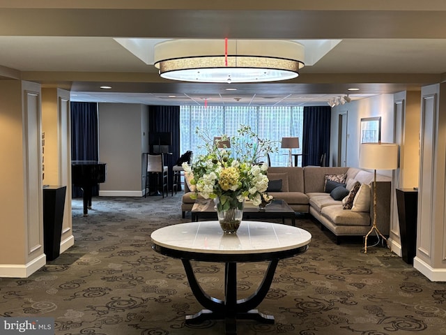 4601 N Park Ave Unit 909, Chevy Chase, MD 20815 - living area with baseboards and dark carpet