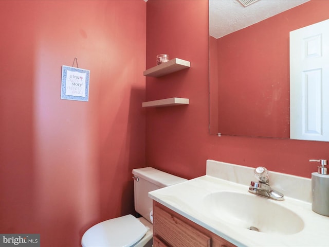 1204 S Fork Dr, Front Royal, VA 22630 - half bathroom with toilet, vanity, and a textured ceiling