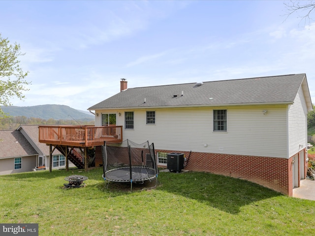 1204 S Fork Dr, Front Royal, VA 22630 - back of house featuring a deck with mountain view, stairway, an outdoor fire pit, a chimney, and a lawn