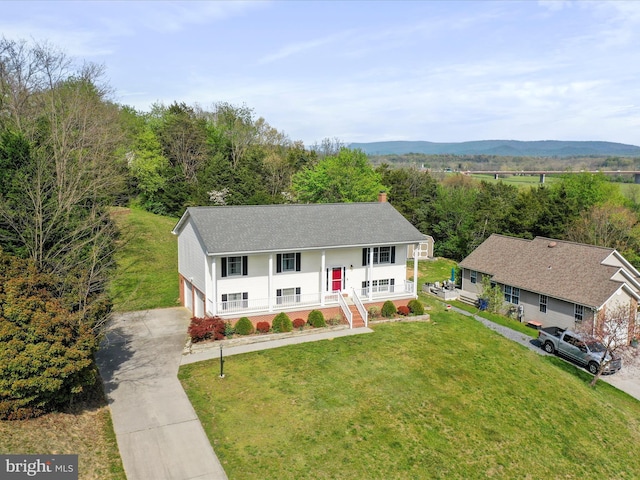 1204 S Fork Dr, Front Royal, VA 22630 - raised ranch with covered porch, a front yard, a garage, concrete driveway, and a chimney