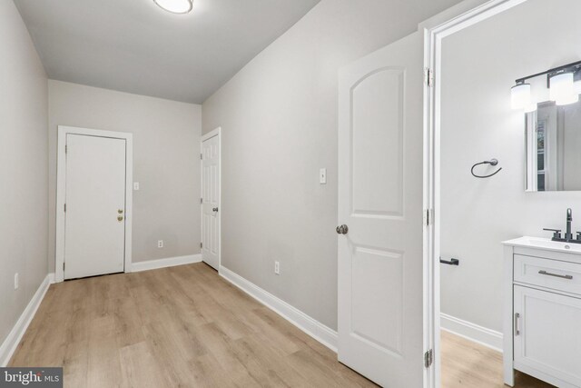 308 S 56th St, Philadelphia, PA 19143 - hall with light wood-style floors, baseboards, and a sink