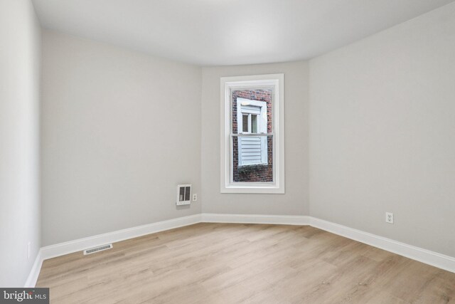 308 S 56th St, Philadelphia, PA 19143 - empty room featuring light wood finished floors, heating unit, and baseboards