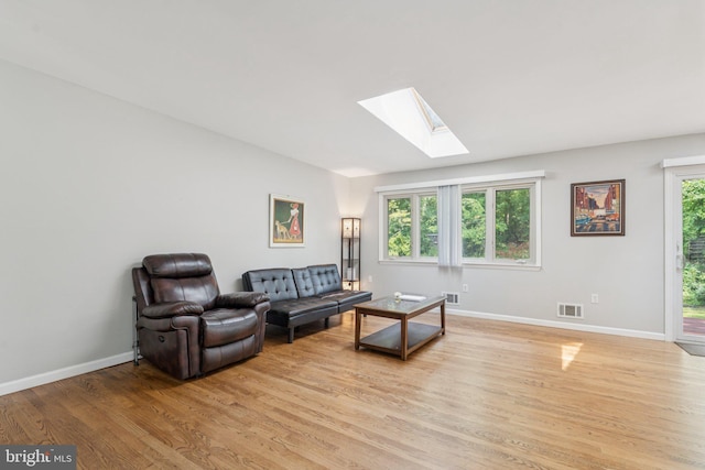 9207 Bois Ave, Vienna, VA 22182 - living room with a skylight and light wood-style floors
