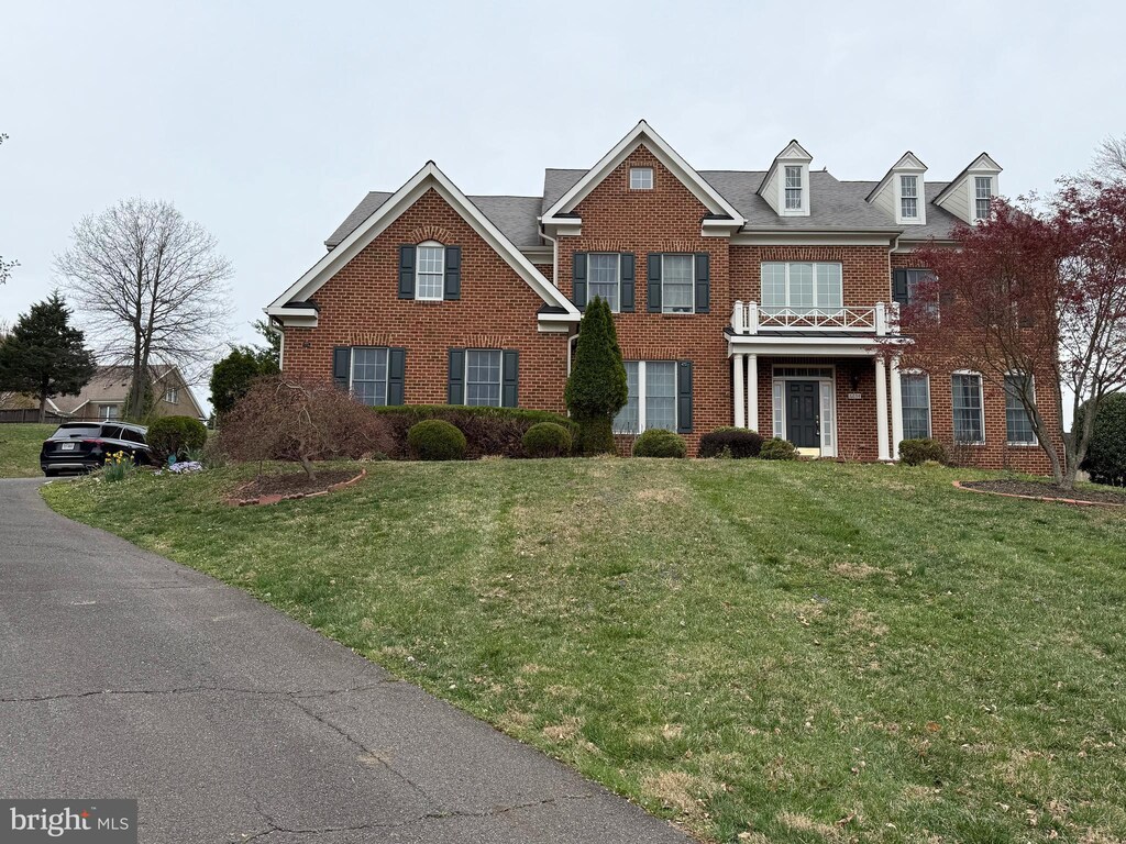 6634 Brawner St, Mclean, VA 22101 - colonial inspired home featuring brick siding and a front yard