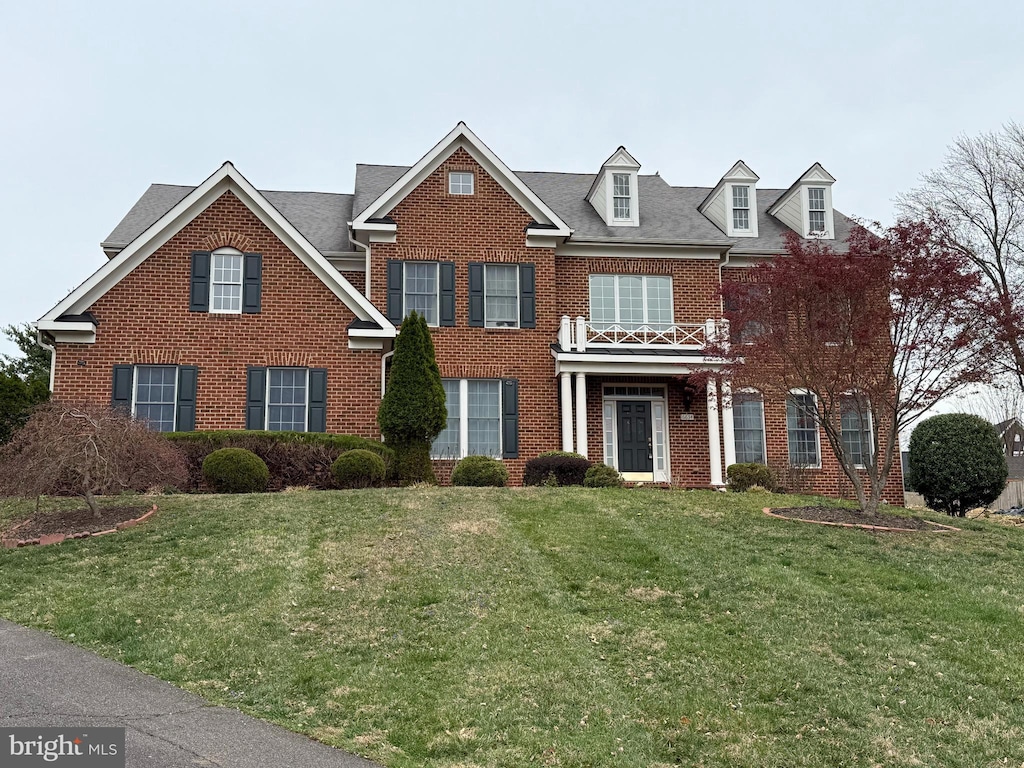 6634 Brawner St, Mclean, VA 22101 - colonial inspired home featuring brick siding, a front yard, and a balcony