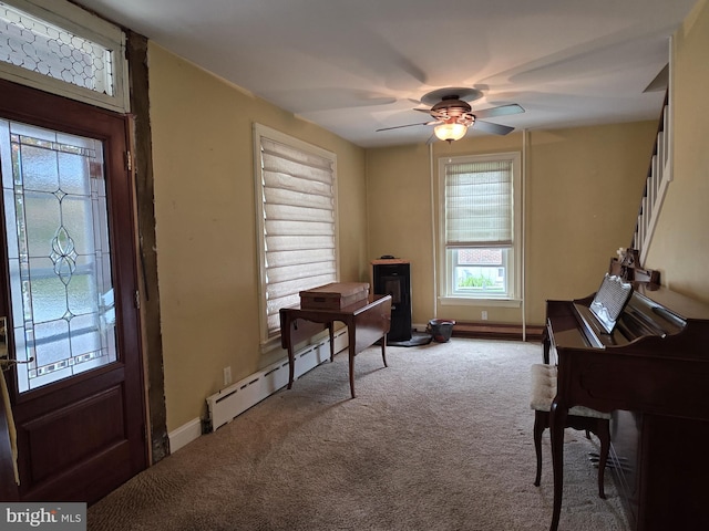 120 S Morwood Ave, Reading, PA 19609 - sitting room featuring a baseboard heating unit, carpet flooring, ceiling fan, and a wood stove