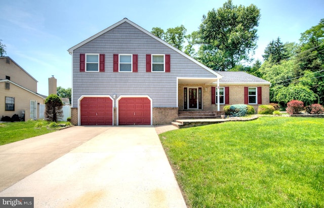 1 Wembley Dr, Mount Laurel, NJ 08054 - split level home with a garage, concrete driveway, a front yard, and brick siding