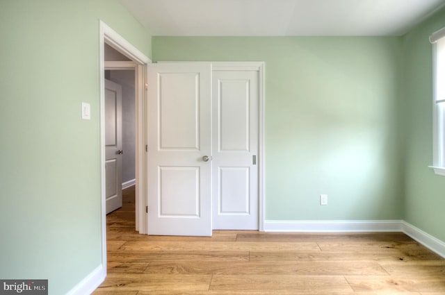 1 Wembley Dr, Mount Laurel, NJ 08054 - unfurnished bedroom featuring light wood-type flooring, baseboards, a closet, and multiple windows