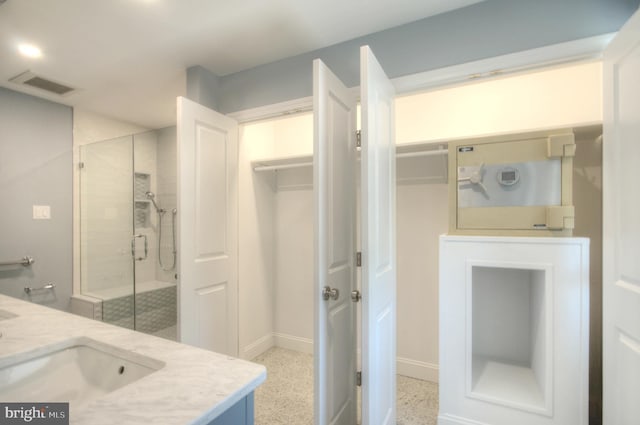 1 Wembley Dr, Mount Laurel, NJ 08054 - full bath featuring a shower stall, double vanity, baseboards, and speckle patterned floor