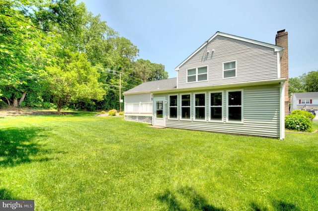 1 Wembley Dr, Mount Laurel, NJ 08054 - rear view of house featuring a chimney, a lawn, and a deck