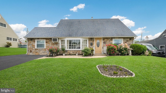 126 Heartwood Rd, Levittown, PA 19056 - cape cod-style house featuring stone siding, a front yard, and roof with shingles