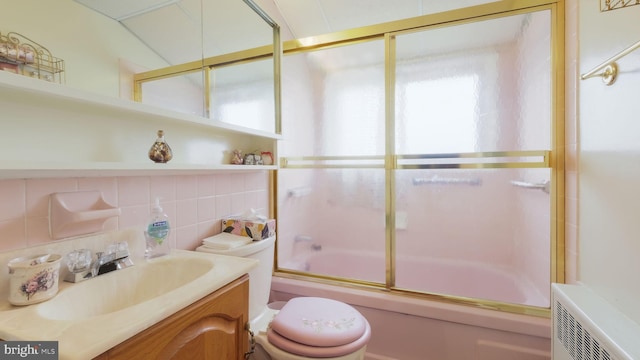 126 Heartwood Rd, Levittown, PA 19056 - full bath featuring vanity, combined bath / shower with glass door, toilet, plenty of natural light, and tile walls