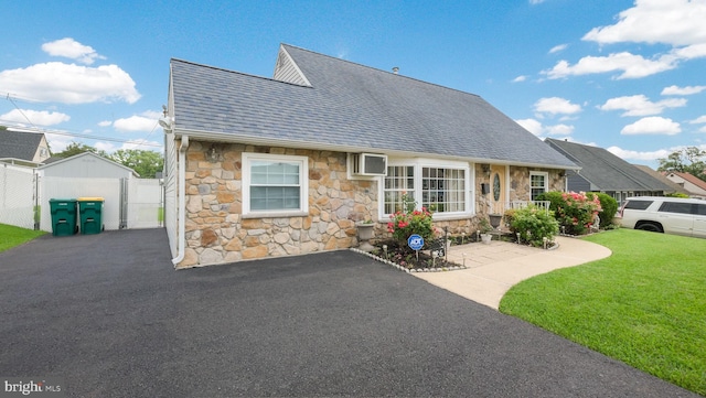 126 Heartwood Rd, Levittown, PA 19056 - view of front of house featuring stone siding, roof with shingles, and a gate