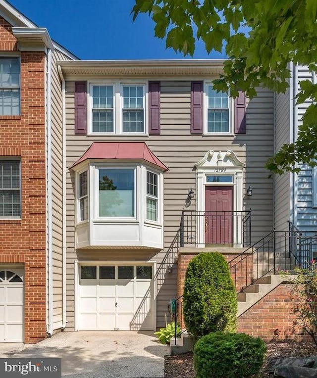 12784 Dogwood Hills Ln, Fairfax, VA 22033 - townhome / multi-family property with stairway, a garage, and driveway
