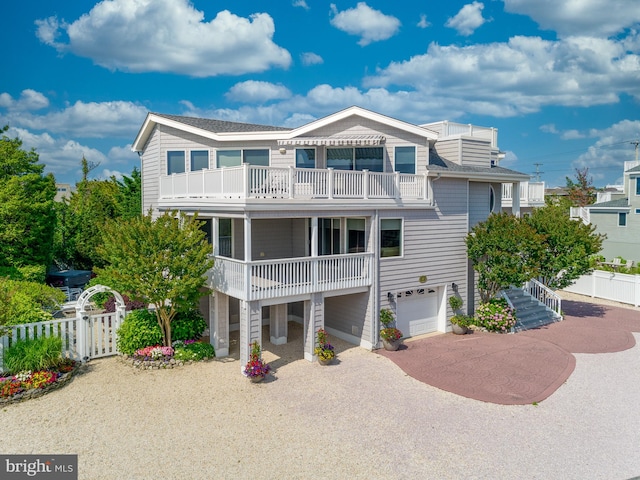 32-B Long Beach Blvd, Long Beach Township, NJ 08008 - view of front facade featuring a balcony, a garage, driveway, and a shingled roof