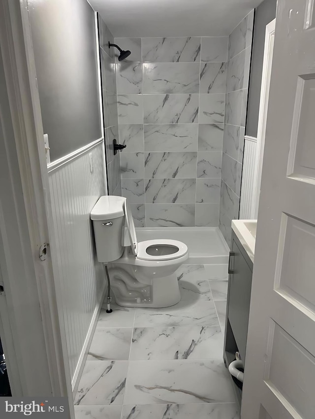 1105 N Chestnut St, Paulsboro, NJ 08066 - full bathroom with toilet, marble finish floors, vanity, a shower stall, and wainscoting