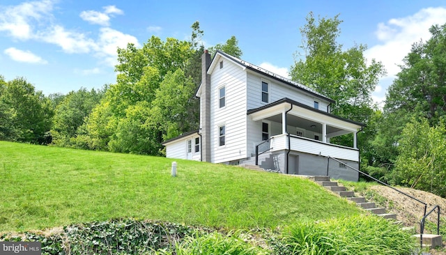 223 One Mile Run Rd, Philipsburg, PA 16866 - view of home's exterior featuring a chimney, a yard, stairway, and covered porch