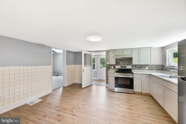 223 One Mile Run Rd, Philipsburg, PA 16866 - kitchen with appliances with stainless steel finishes, plenty of natural light, light wood-style floors, and wainscoting