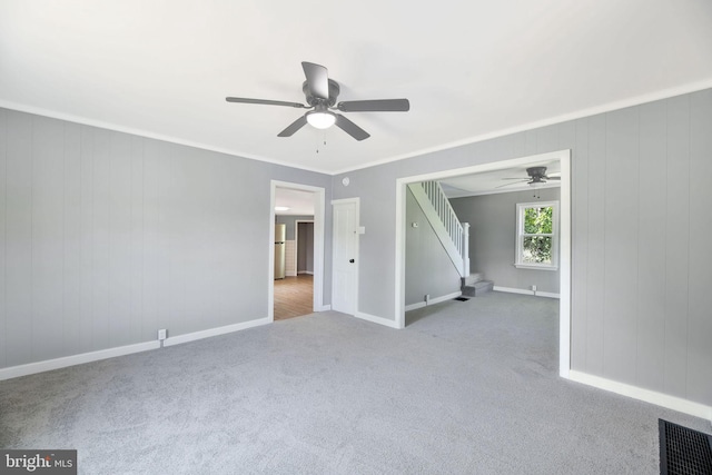 223 One Mile Run Rd, Philipsburg, PA 16866 - spare room featuring a ceiling fan, carpet, stairs, baseboards, and crown molding