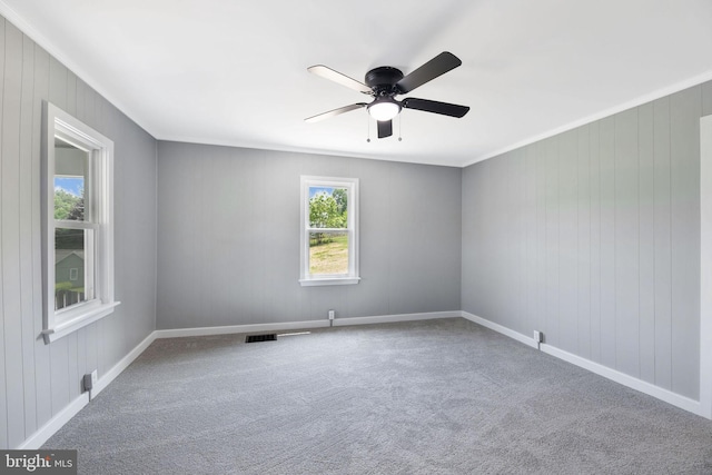 223 One Mile Run Rd, Philipsburg, PA 16866 - carpeted empty room with ornamental molding, ceiling fan, baseboards, and wood walls