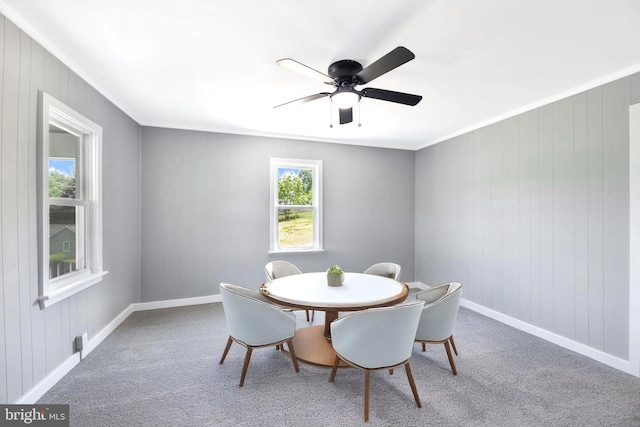 223 One Mile Run Rd, Philipsburg, PA 16866 - carpeted dining space featuring ceiling fan, crown molding, baseboards, and wood walls