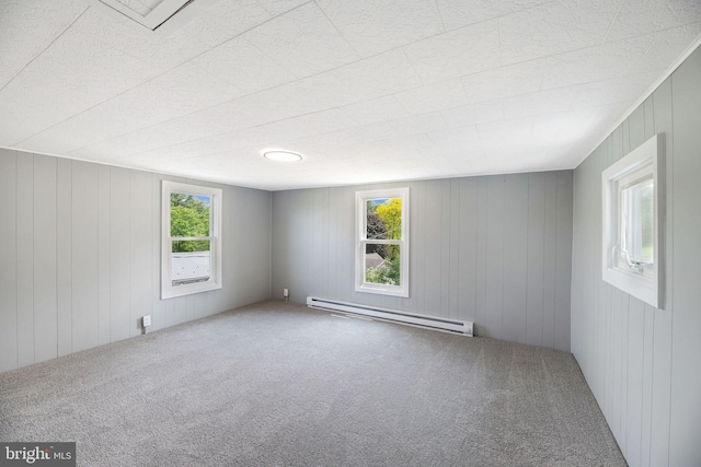 223 One Mile Run Rd, Philipsburg, PA 16866 - carpeted spare room featuring a baseboard heating unit and wood walls