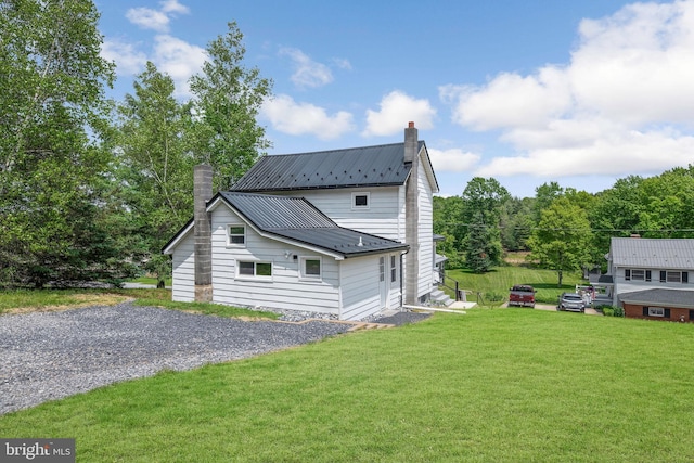 223 One Mile Run Rd, Philipsburg, PA 16866 - view of side of property featuring a chimney, a lawn, and metal roof