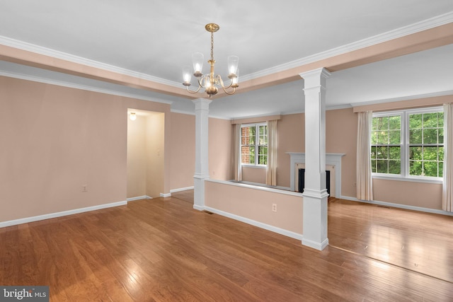 4849 Carriagepark Rd, Fairfax, VA 22032 - unfurnished living room with wood finished floors, crown molding, a chandelier, baseboards, and decorative columns