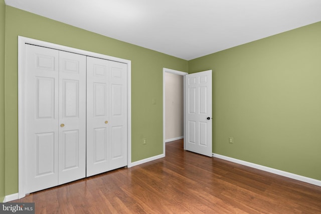 4849 Carriagepark Rd, Fairfax, VA 22032 - unfurnished bedroom featuring baseboards, wood finished floors, and a closet